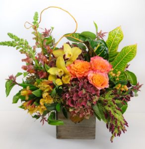 peach roses and yellow lilies in box with greenery