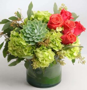 green hydrangeo red roses and succulent in vase