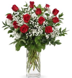 long stemmed roses - a classic look! Arranged with million star babies breath, and mixed greenery in a clear glass vase.