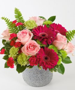 Premium pink Roses designed with Gerbera Daisies and other accenting flowers in the pinks and greens color palette. This bouquet comes in a beautiful designer ceramic container. 